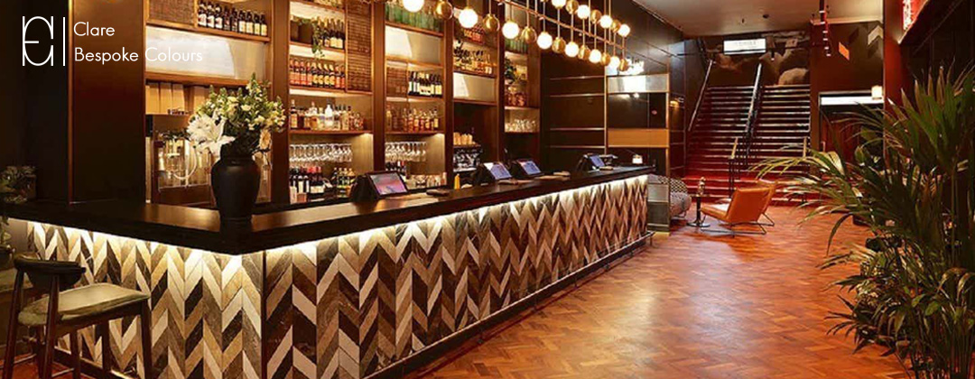 Brown and white marble tiles used to create a chevron pattern